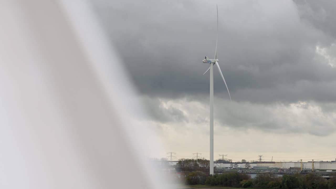 Wind turbine turning in the wind at Hook of Holland, on a cloudy stormy day