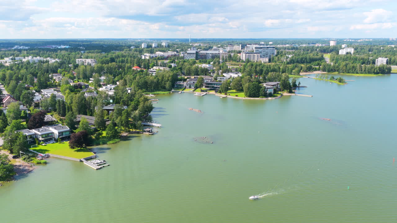 Drone rotating along the shoretline of Westend, sunny day in Espoo, Finland