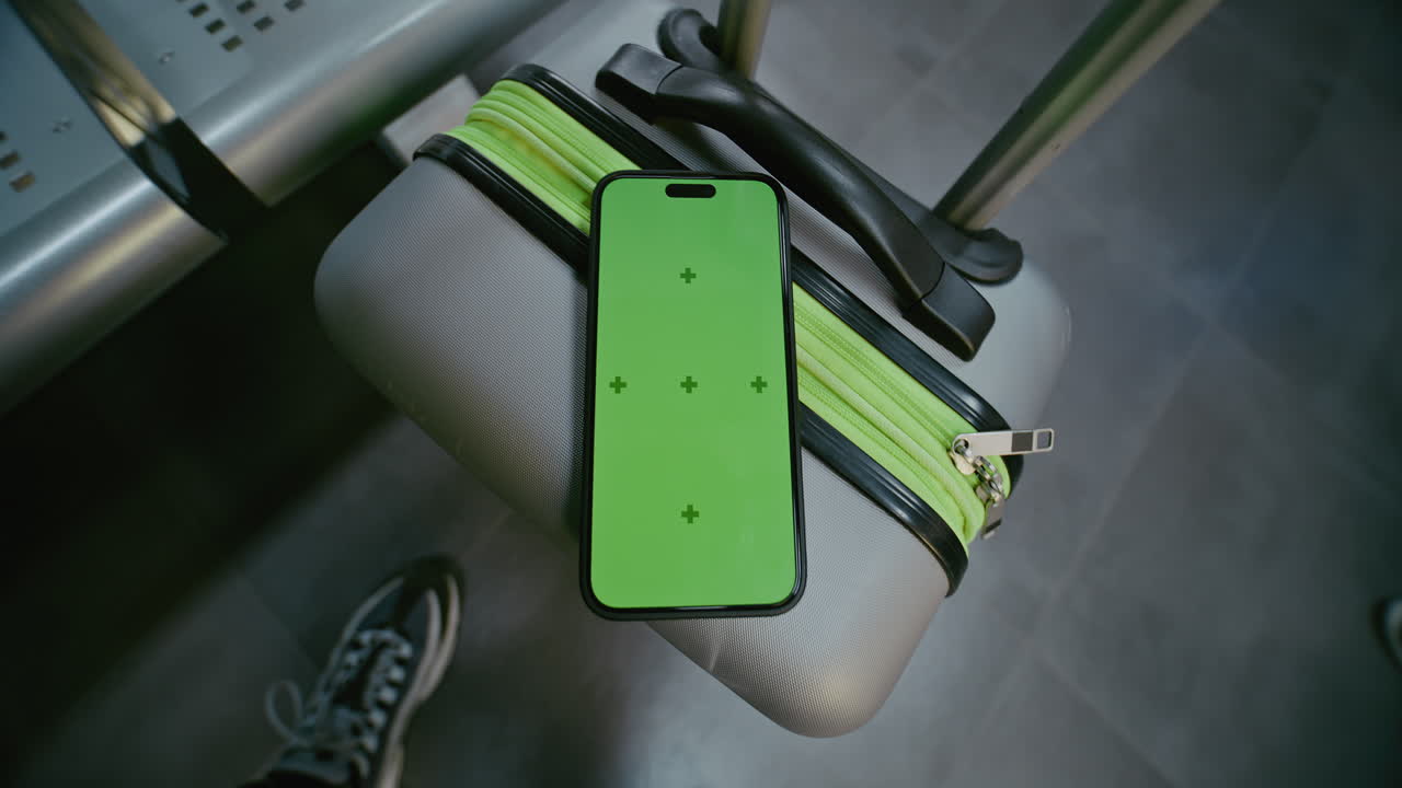 Smartphone on Suitcase in Airport