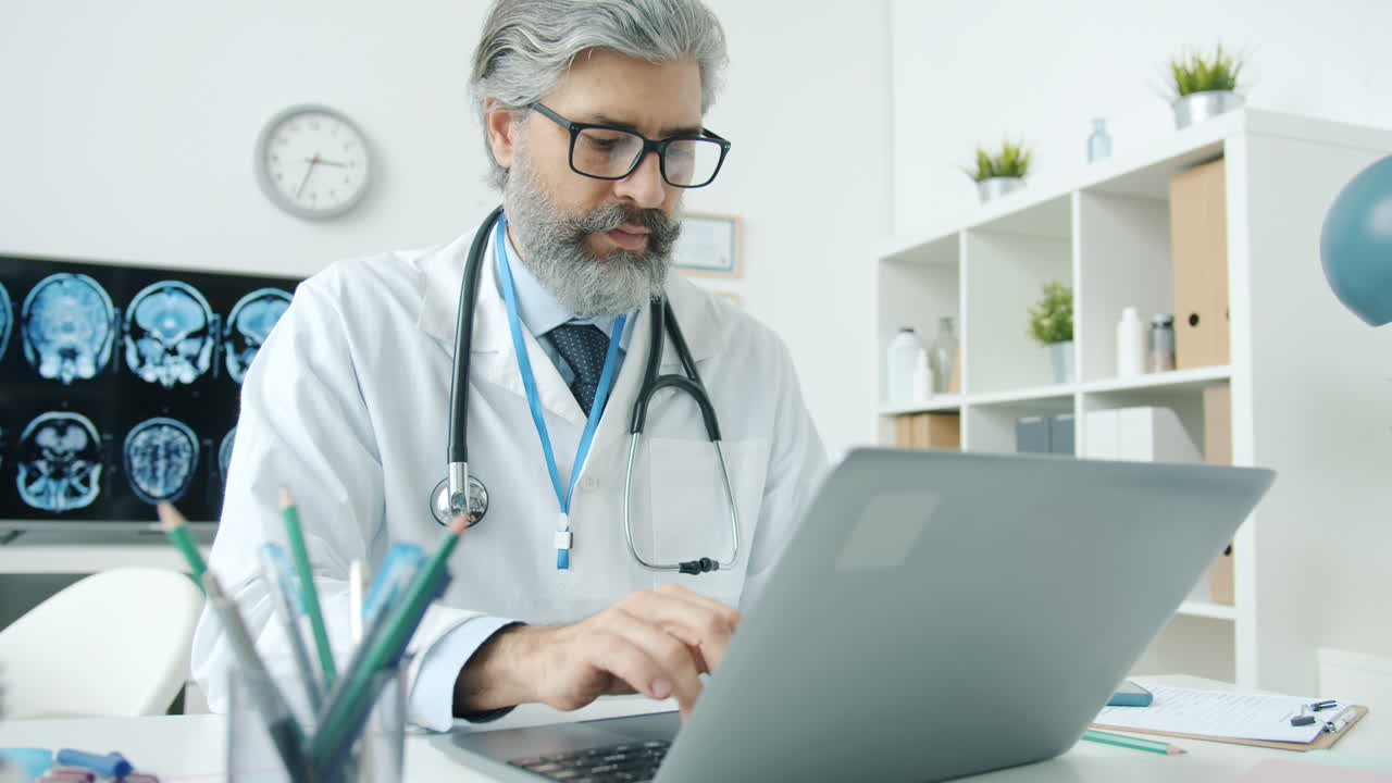 Doctor Working on a Laptop in a Clinic