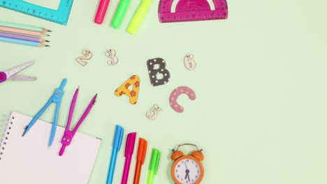 school writing stationery move on light green background. stop motion