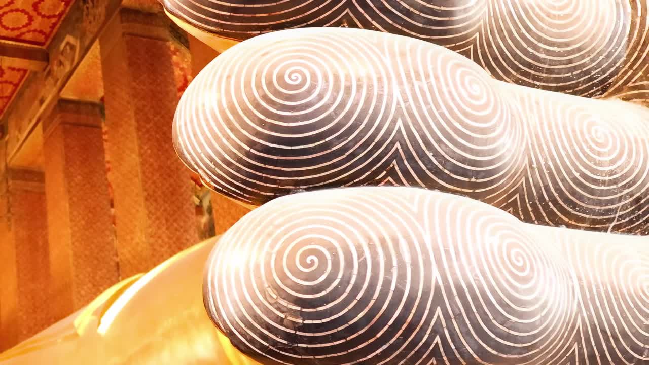 Close-up view of the detailed spiral patterns on a Buddha statue's sole, highlighting craftsmanship and artistry.