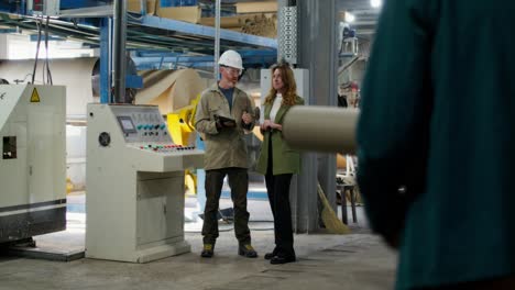 factory workers inspecting machinery