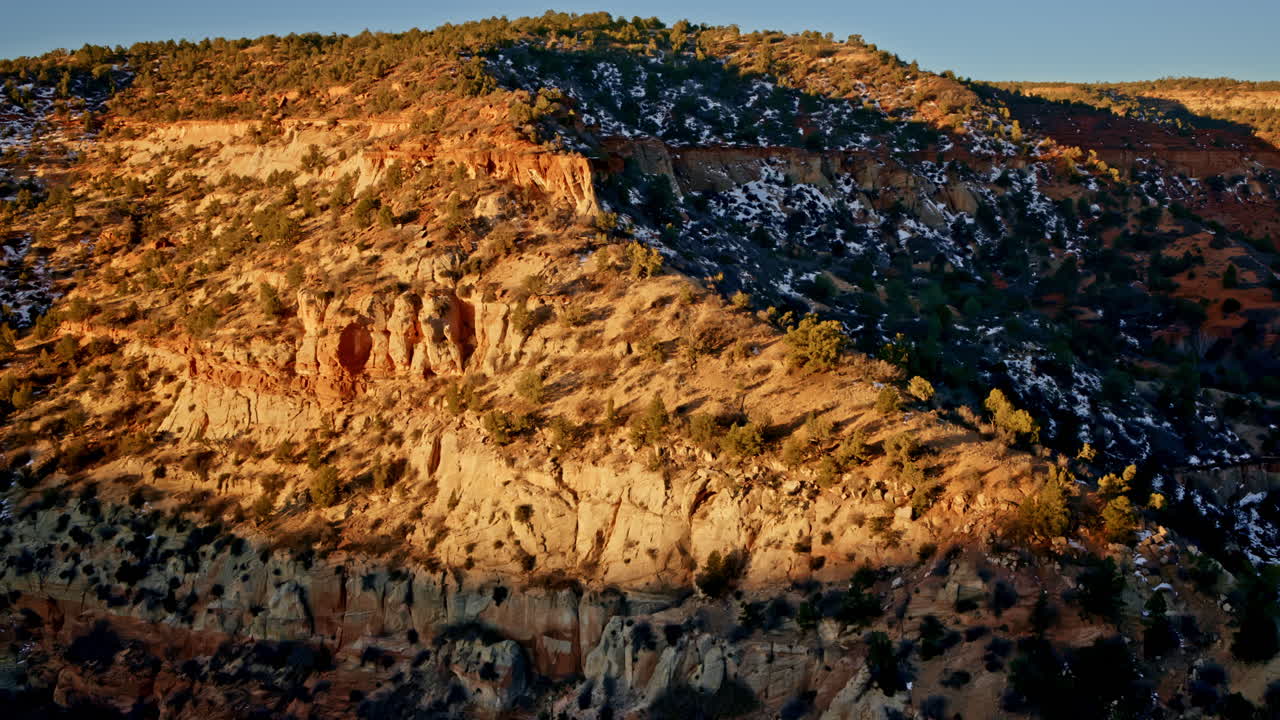 Overhead drone view showcasing a spectacular rock arch as the sun rises near Kanab.