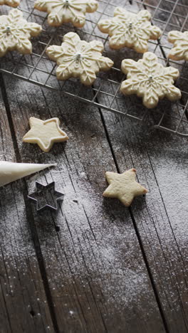 vertical video of star christmas cookies with sugar and copy space on wooden background