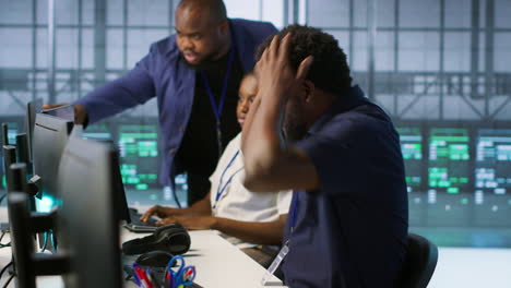 Diverse team of IT professionals working in a control room
