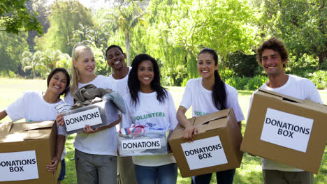 group of young volunteers holding donation boxes