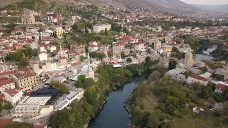 aerial shot of mostar in bosnia and herzegovina, wide shot of mostar old town with the river neretva in the centre