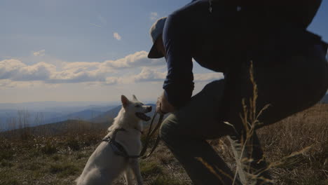 backpacker and his dog at the top of the hill