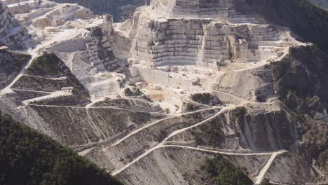 view of the carrara marble quarries and the transport trails carved into the side of the mountain