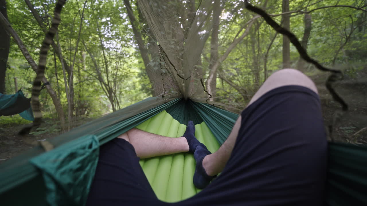 Relaxing in a hammock in the forest, enjoying nature's tranquility