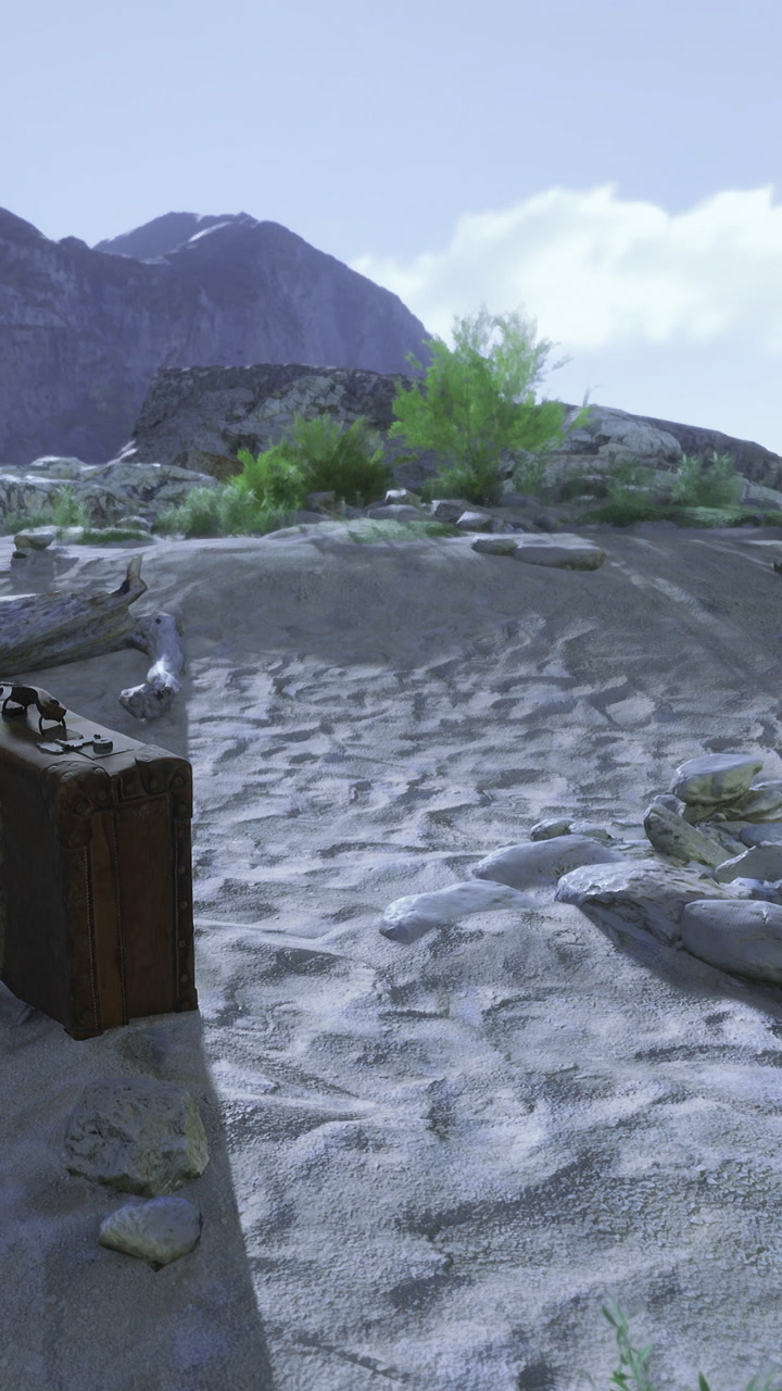 Desert landscape with a suitcase next to rocks and sparse vegetation