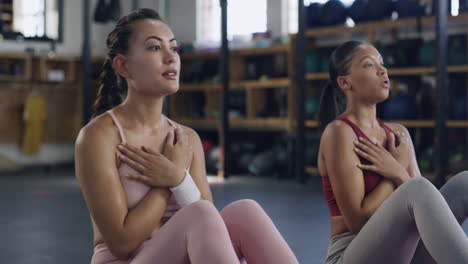 two active friends exercising together in the gym
