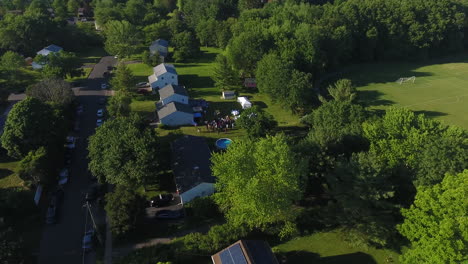 aerial pan out of a neighborhood with a clear blue sky