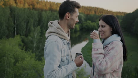 couple enjoying a drink in nature
