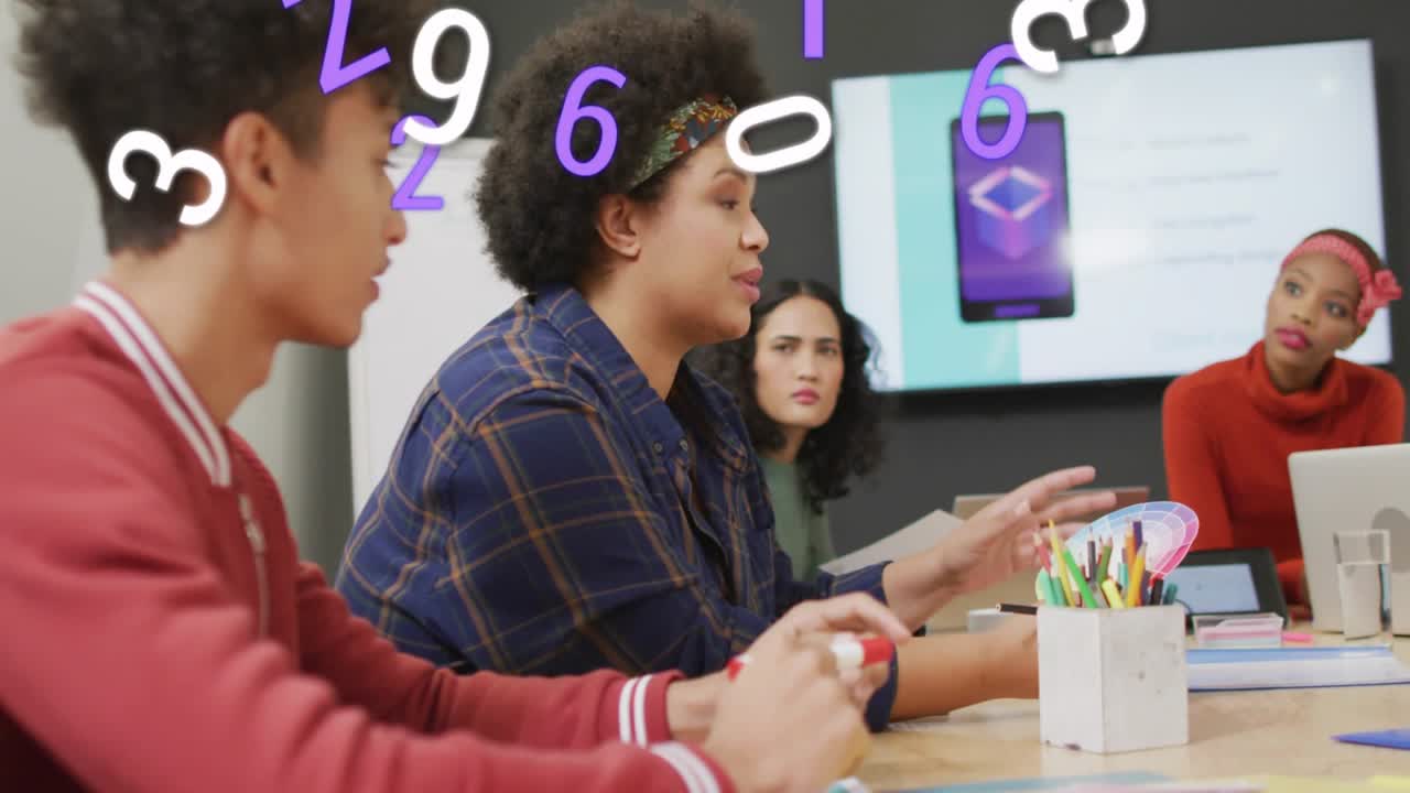 Lead designer holding swatch, starting animated numbers over monitor and team, showing colors