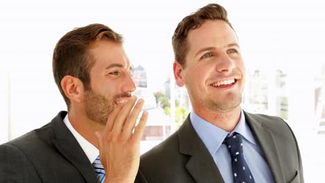 smiling businessmen chatting together