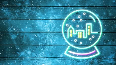 Snowflakes-falling-over-neon-snow-globe-against-blue-wooden-background