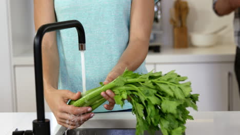 couple cleaning vegetables