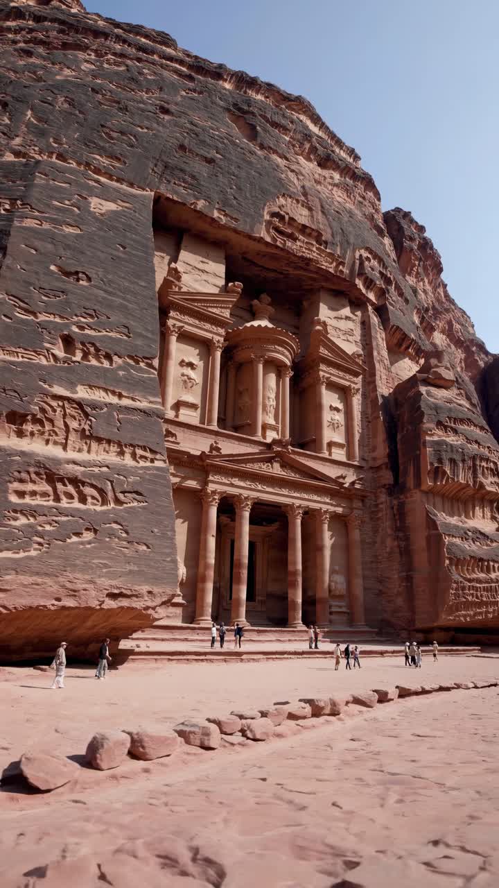 Wide-angle shot of Petra's iconic facade, capturing the ancient architecture and visitors