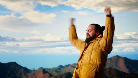 satisfied adventure seeker stands at the top a towering mountain