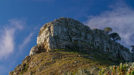 a rocky mountain landscape with a paraglider in the sky