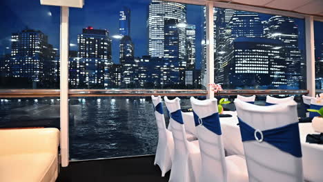 Inside the restaurant on board of the riverboat. Dazzling skyline of New York in the windows