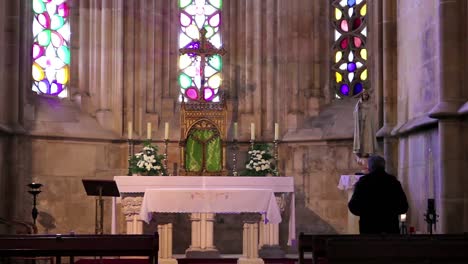 man sitting inside a church while praying to god faith and religion concept