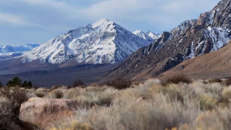 snow covered mount tom mt thompson prominent towering peak west bishop california aerial drone tall grass morning winter mountain sierra nevada range big pine rocky desert round valley slide left