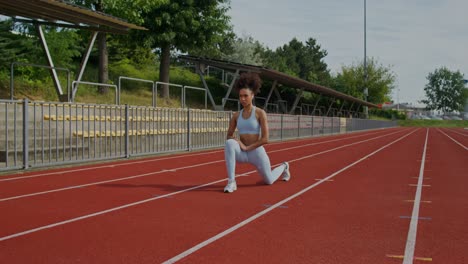 woman stretching on a track