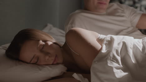 couple sleeping together in bed