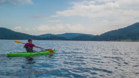 kayaking solo on a serene mountain lake