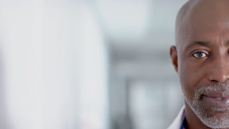 Portrait-of-happy-african-american-male-doctor-smiling,-copy-space,-slow-motion