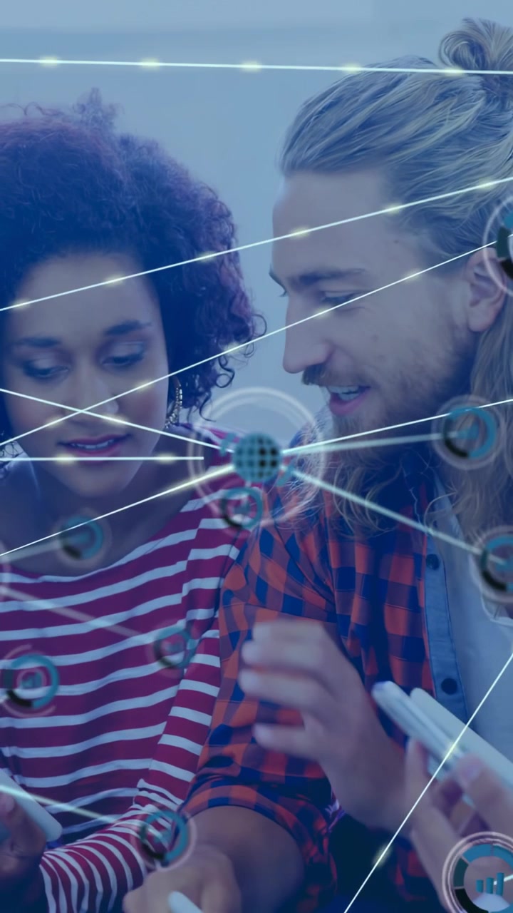 Vertical video: Woman tapping tablet, overlay growing into network linking devices, sharing data