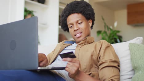 african american man using laptop at home