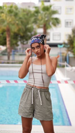 woman in fashionable summer attire by a pool