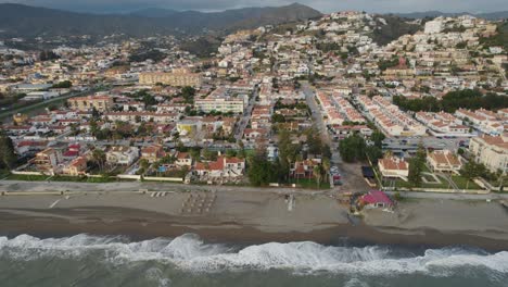 Drone-flight-over-the-coastline-of-Malaga-towards-the-Mediterranian-sea-shows-the-beach-and-the-huge-size-of-the-city