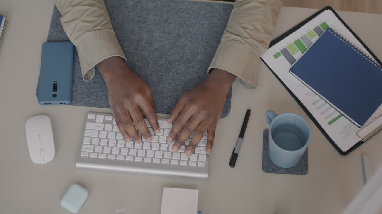 Person Typing on a Computer at a Desk