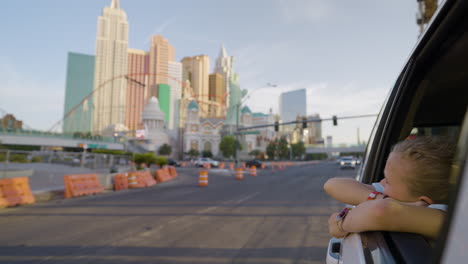 person looking out car window at the las vegas strip