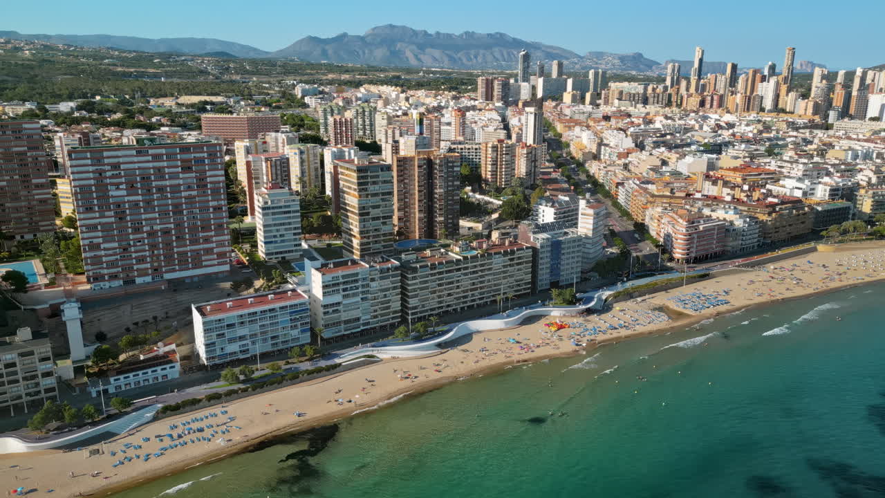 Aerial drone view of the buildings along the coastline and the sea in Benidorm, Spain in daylight