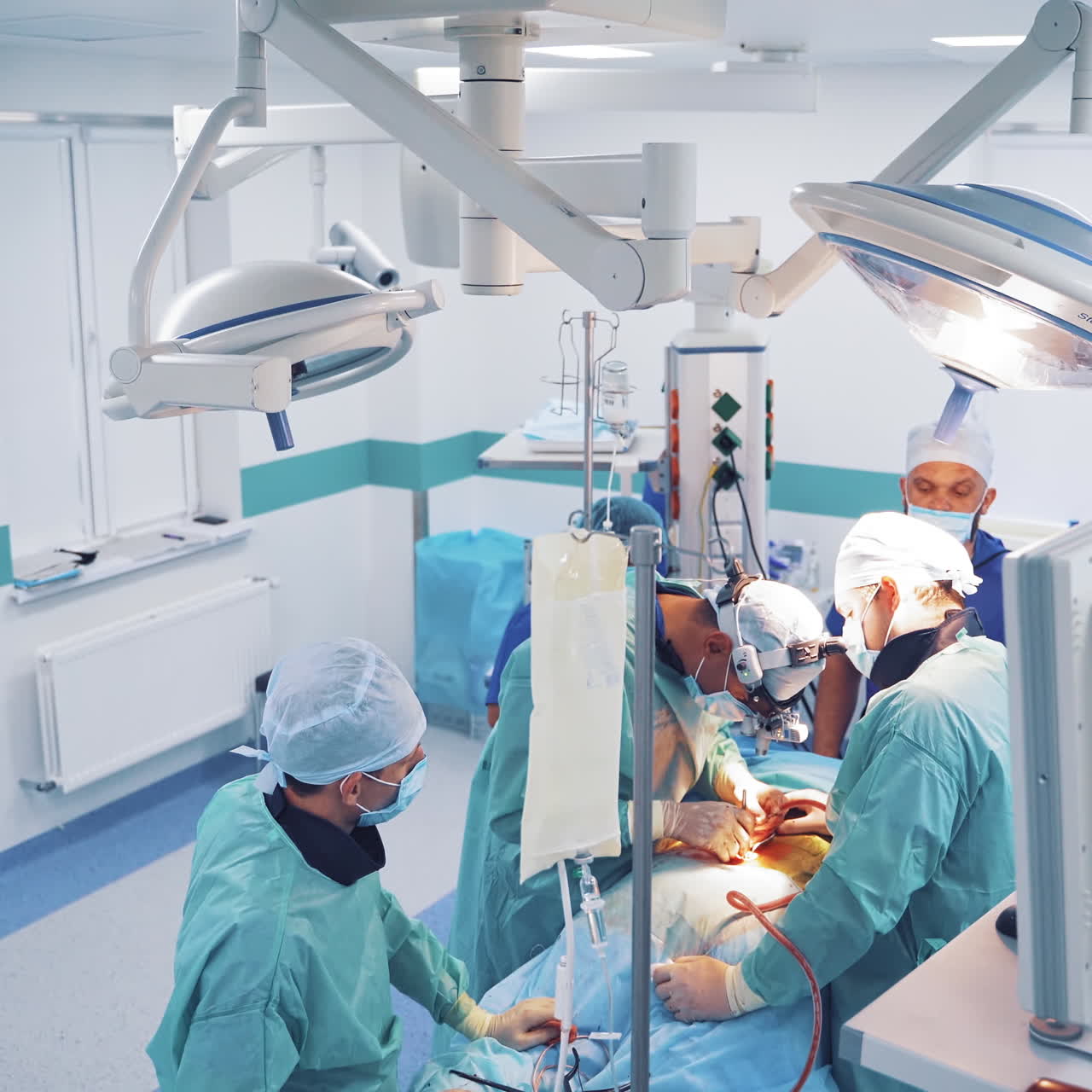 Operating process in clinic. Teamwork of professional medical workers in modern operating room in a private hospital.