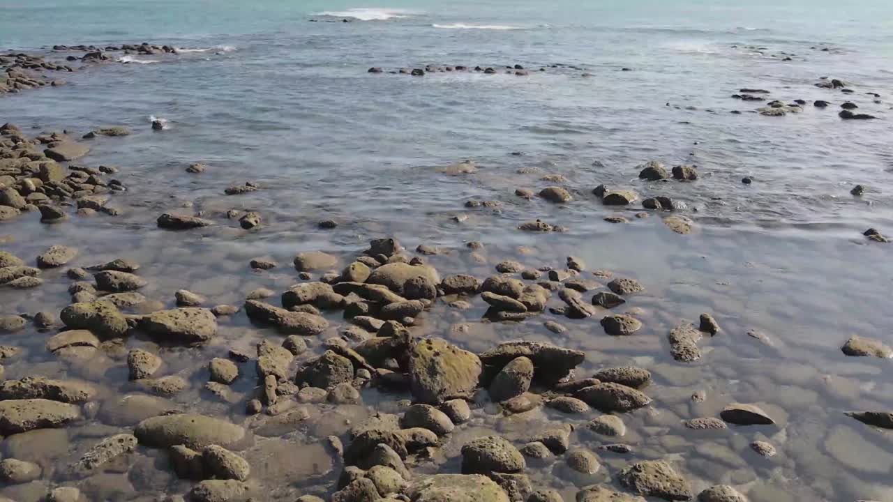 Costa rocciosa di un'isola tropicale in vista all'indietro con gimbal