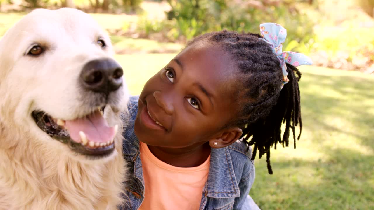 귀여운 소녀의 초상화가 개를  ⁇ 고 있다