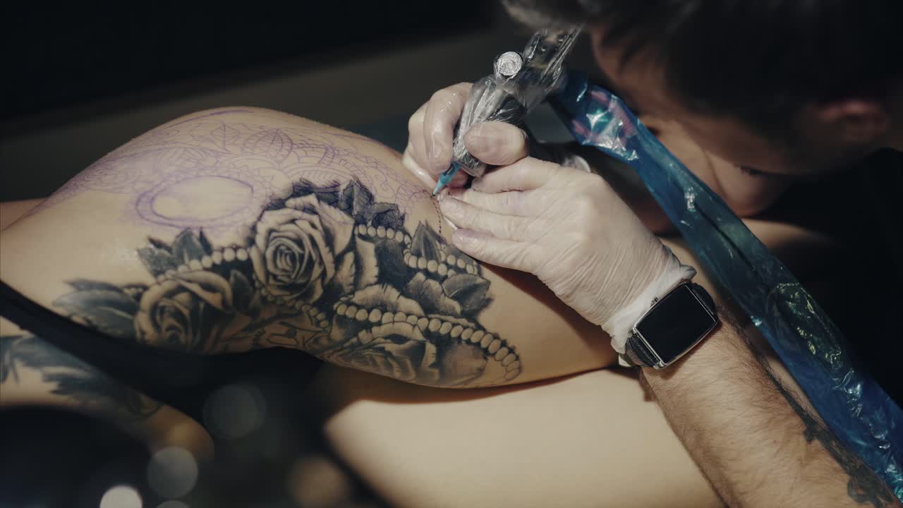 Tattoo Artist Working on a Hip Tattoo