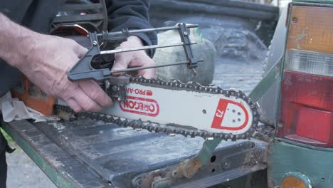 man attaching file to sharpen chainsaw blade