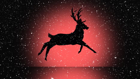 snow falling over silhouette of reindeer running against orange background