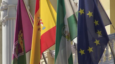 banderas de europa, españa, andalucía y málaga, colgando en el ayuntamiento