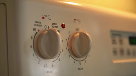 woman's hand turning off the fire, on the kitchen