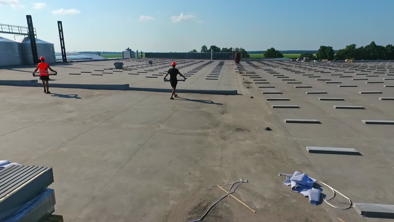 Construction from drone view. Aerial view of big construction site working on roof