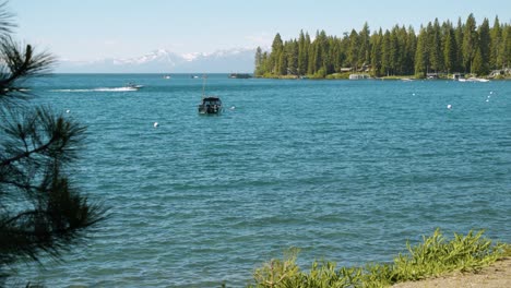 Boating-on-Lake-Tahoe-with-snowy-Sierra-Nevada-mountains-in-background